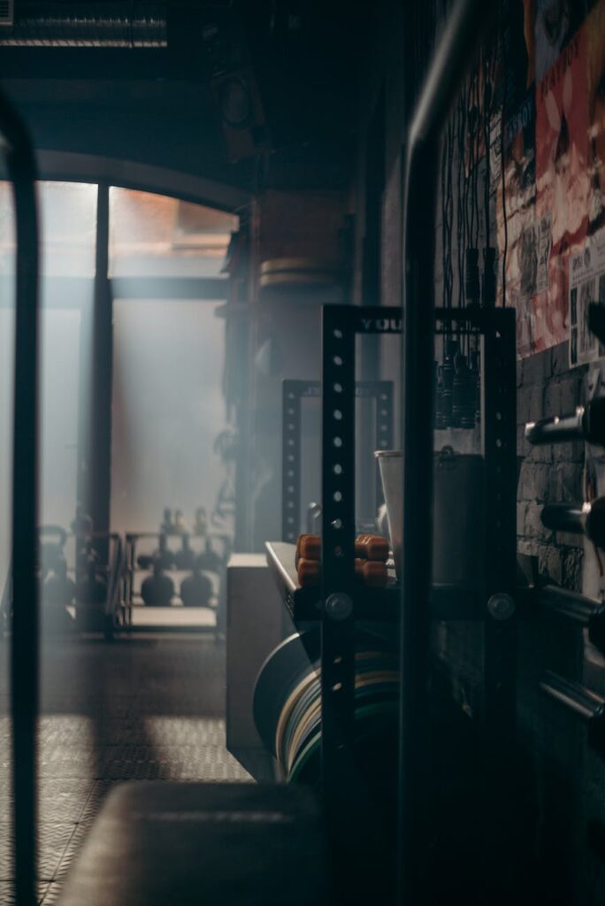 pexels-photo-4753890-4753890-2 A dark and atmospheric gym interior showcasing weights and fitness equipment with dramatic lighting.